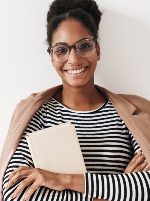 portrait-of-african-american-happy-woman-laughing-and-holding-book-e1624349115709.jpg